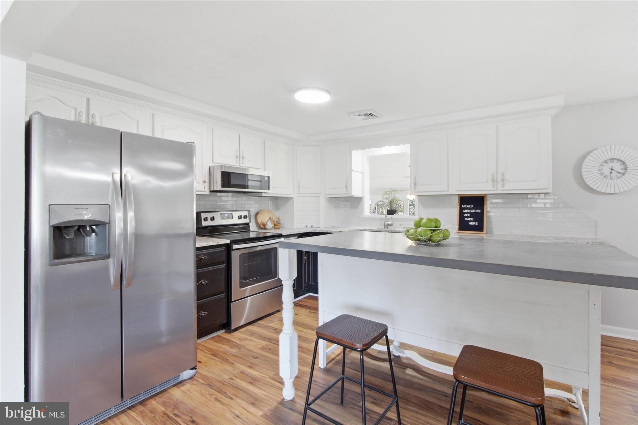 2571 Locust Road Dover, PA 17315 - Photo 3 of 27 a kitchen with cabinets stainless steel appliances and a refrigerator