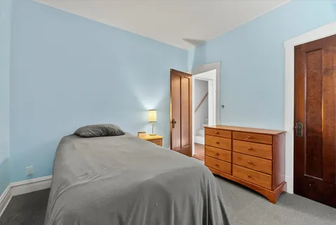 a bedroom with a bed and a dresser