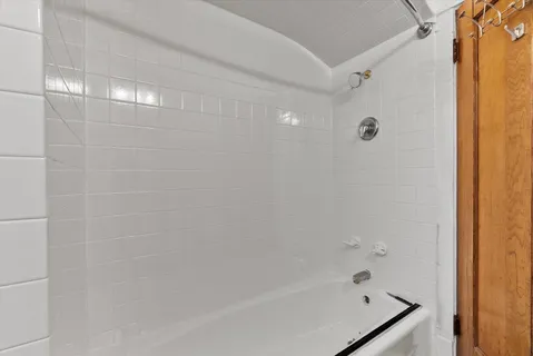 a bathroom with a bathtub and shower
