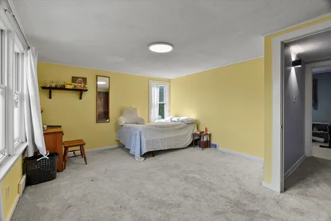 a bedroom with furniture and a window