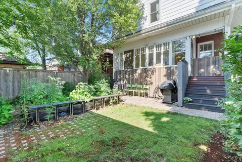 a view of a house with backyard and sitting area