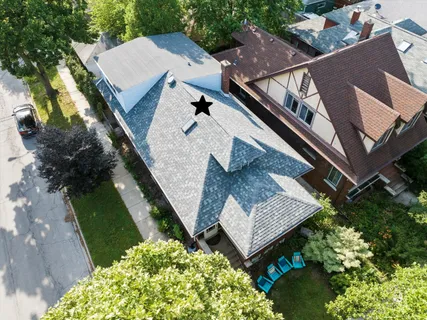 an aerial view of a house with a yard