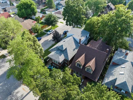 an aerial view of a house with garden space and street view
