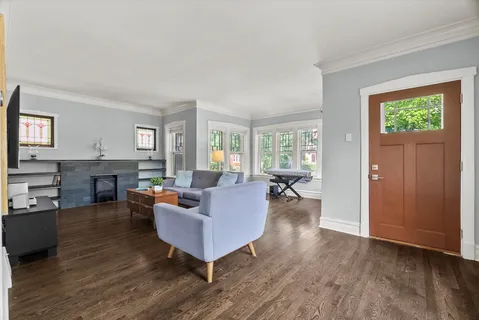 a living room with fireplace furniture and a wooden floor