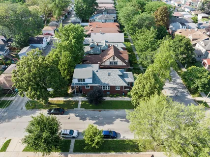 an aerial view of a house with yard swimming pool and outdoor seating