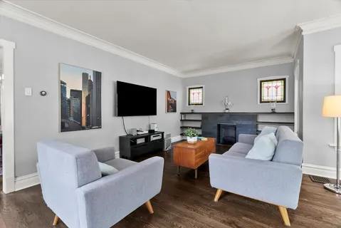 a living room with fireplace furniture and a flat screen tv