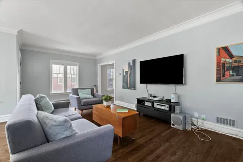 a living room with furniture and a flat screen tv