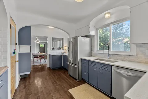a kitchen with refrigerator cabinets and wooden floor