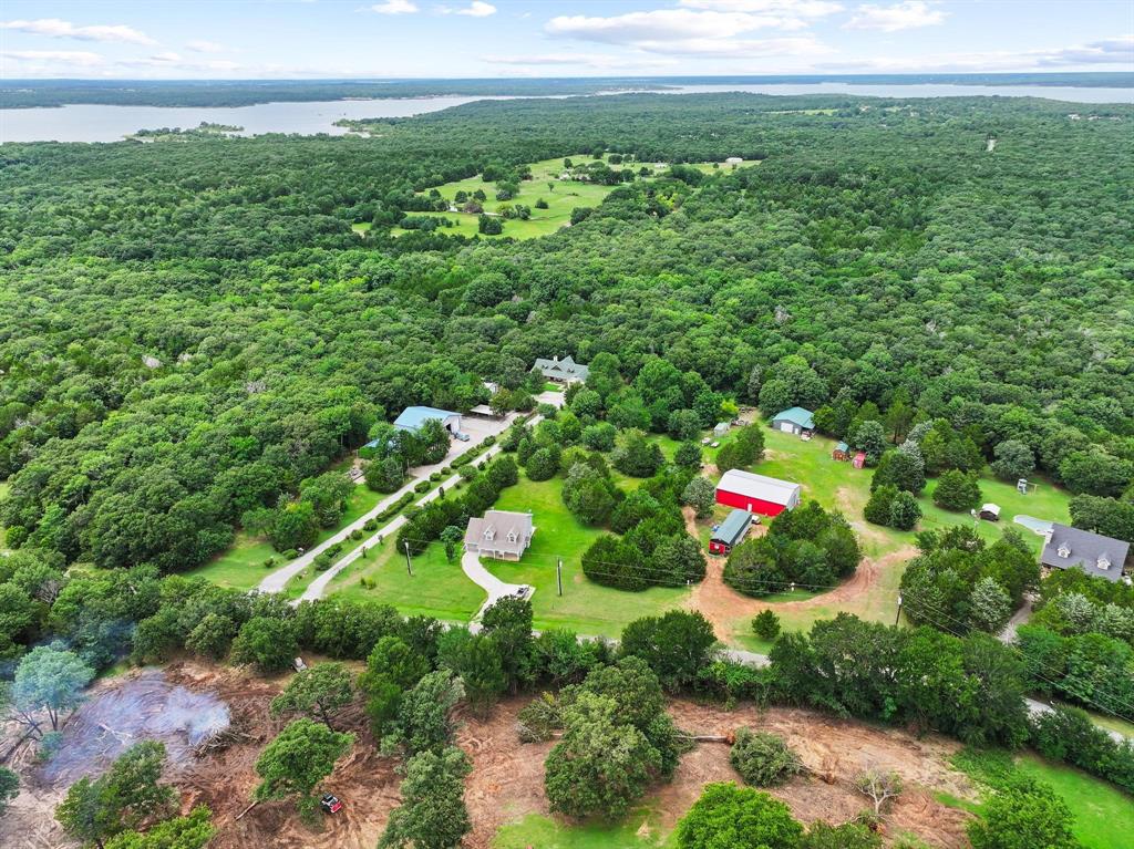 207 Paradise Park Road Pottsboro, TX 75076 - Photo 9 of 28 Expansive rural property featuring a large body of water in the background, surrounded by extensive natural tree cover