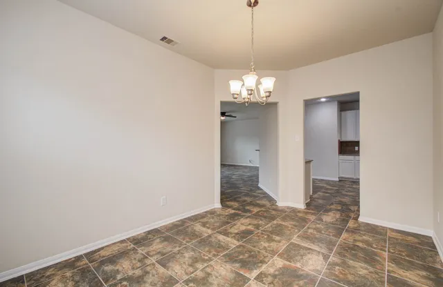 a view of a chandelier in big room and chandelier in a room