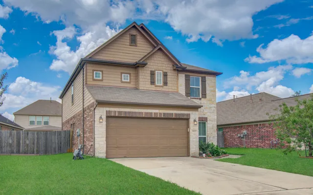 a front view of a house with a yard and garage