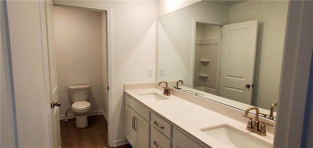 334 Silverleaf Trail Bethlehem, GA 30620 - Photo 14 of 30 a bathroom with a sink a toilet and shower