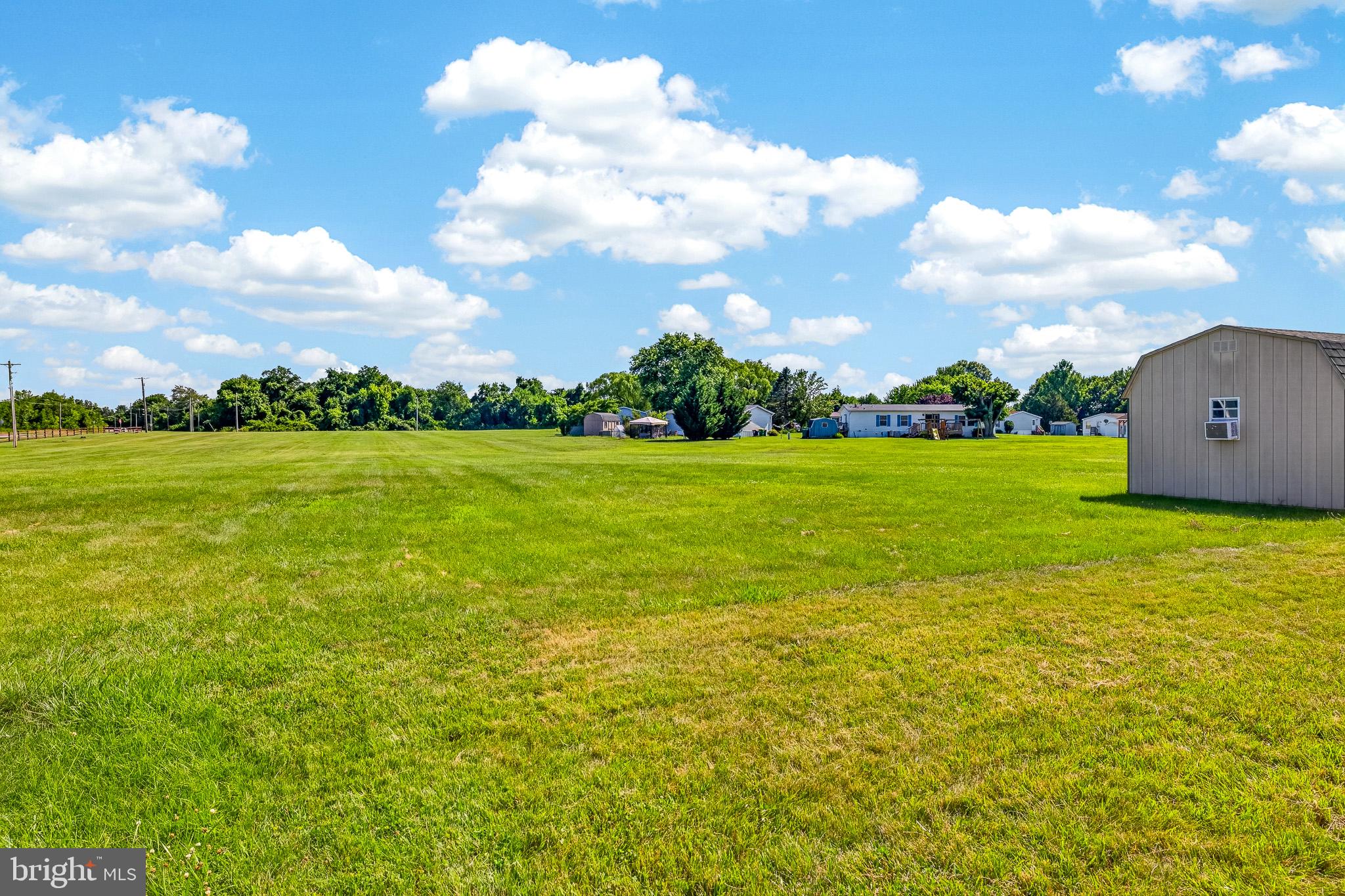 8 West Reybold Drive, Unit 8 Middletown, DE 19709 - Photo 24 of 30 Spacious green lot under blue skies.