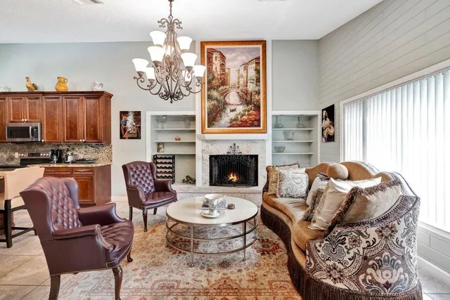 a living room with furniture a fireplace and a window