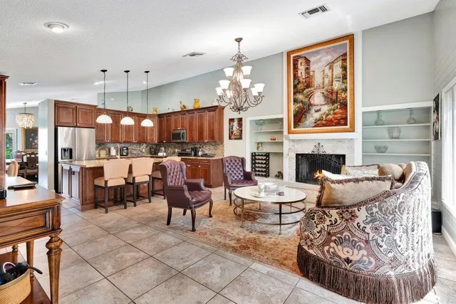 a living room with fireplace furniture and a chandelier