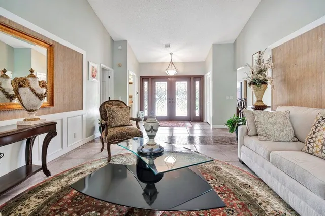 a living room with furniture and a chandelier