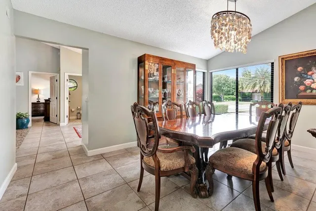 a dining room with furniture a chandelier and a rug