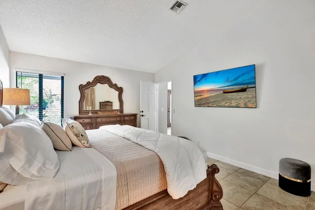 a bedroom with a bed and glass windows