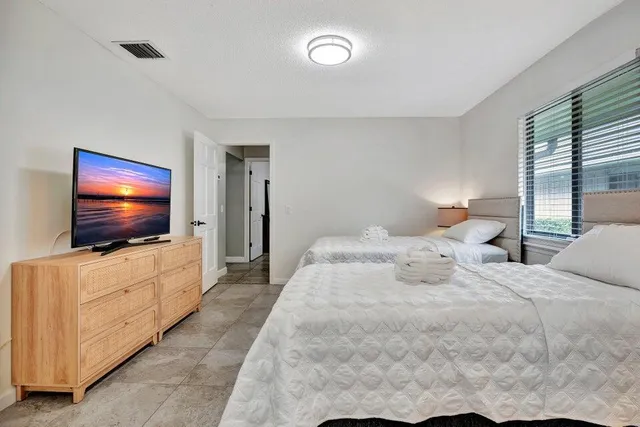 a bedroom with a flat screen tv and a bed