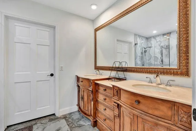 a bathroom with a double vanity sink and a mirror