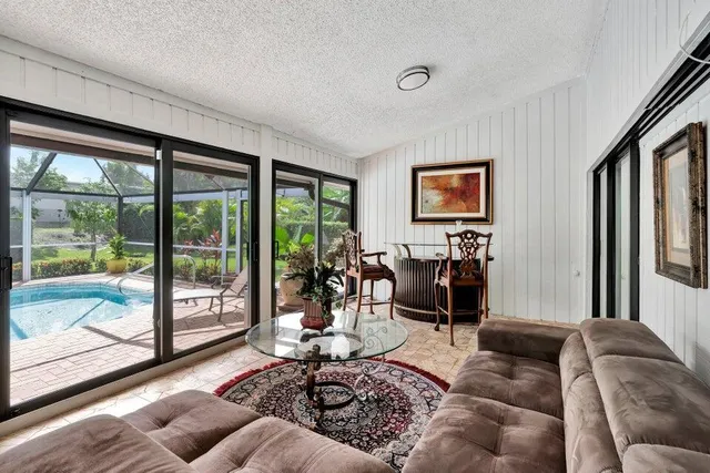 a living room with furniture and a floor to ceiling window