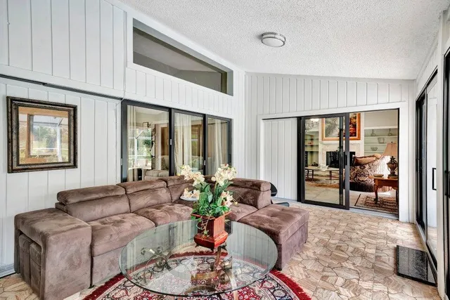 a living room with furniture and large windows