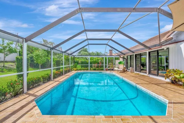 a view of a backyard with swimming pool