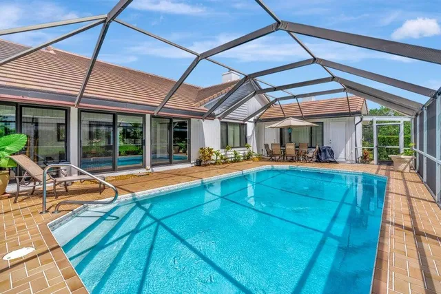 a view of a patio with a table and chairs under an umbrella