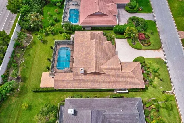 an aerial view of a house with outdoor space and tennis court