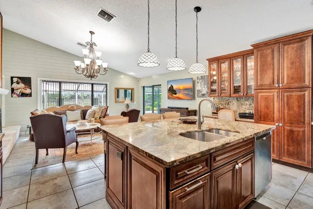 a very nice looking dining room with a large dining table chairs and couches