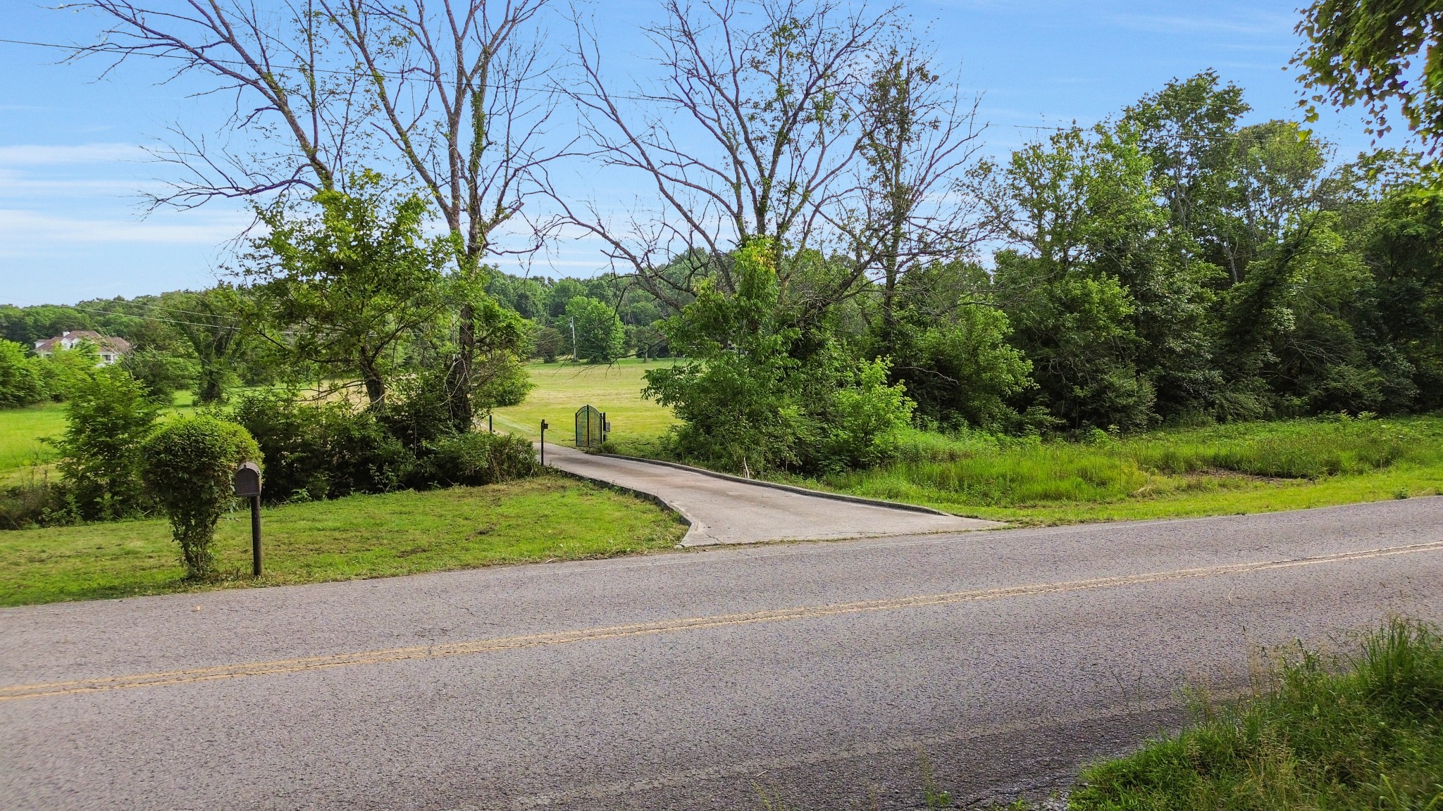 1896 West Harpeth Road Franklin, TN 37064 - Photo 12 of 24 a view of a house with a big yard and palm trees