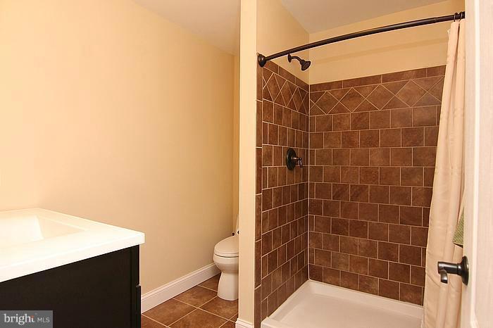 8100 Dalesford Road Baltimore, MD 21234 - Photo 3 of 17 a bathroom with a shower and a toilet