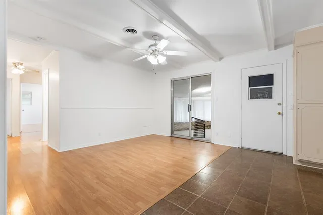 a view of an empty room with closet and a chandelier fan