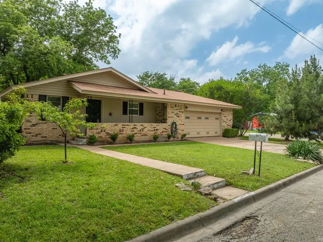 a front view of house with yard and green space