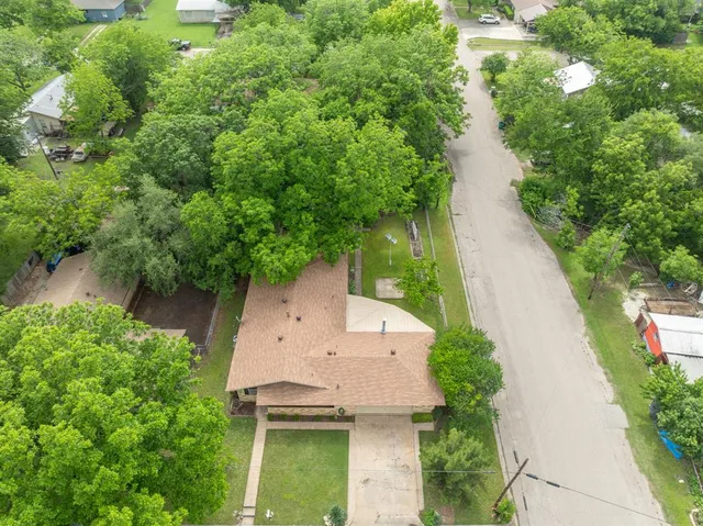 an aerial view of house with yard swimming pool and outdoor seating
