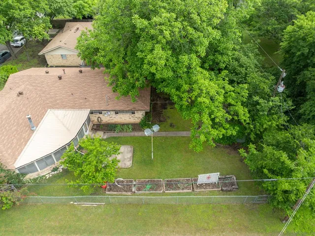 an aerial view of a house with a yard swimming pool and outdoor seating