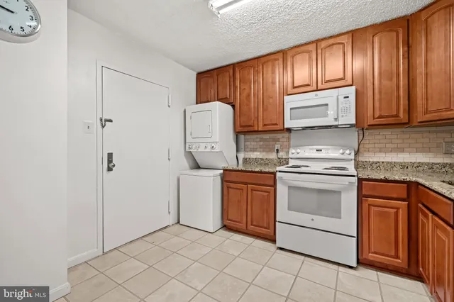 a kitchen with stainless steel appliances granite countertop a stove sink and cabinets