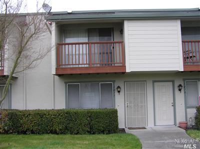 a view of a house with wooden deck and a yard