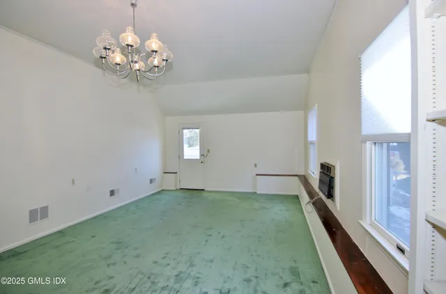 a view of a chandelier fan and window