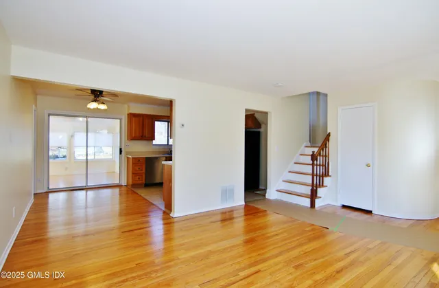 a view of empty room with wooden floor and fireplace