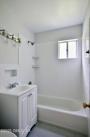 a bathroom with a sink a toilet and bathtub