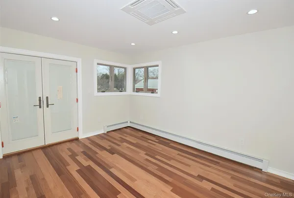 wooden floor in an empty room with a window