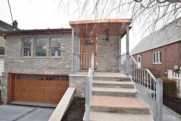 a view of a house with wooden fence and two windows