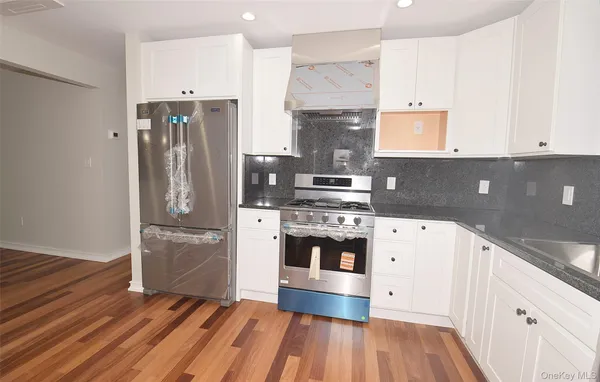 a kitchen with stainless steel appliances a stove and a refrigerator
