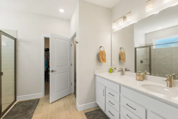 a bathroom with a glass shower door