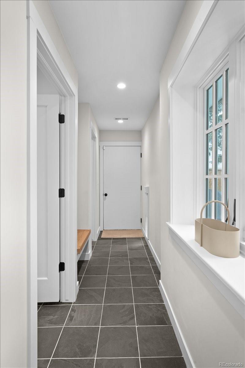 535 Garfield Street Denver, CO 80206 - Photo 23 of 50 a bathroom with a glass door shower a sink and a bathtub