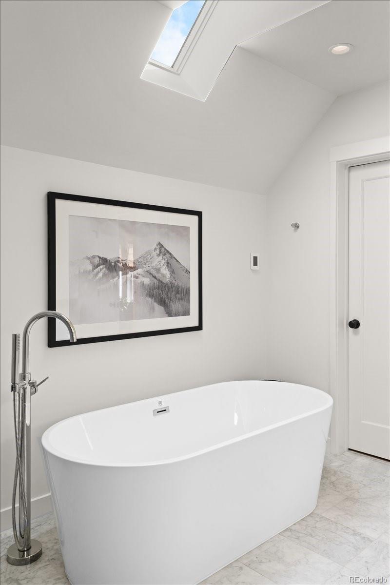 535 Garfield Street Denver, CO 80206 - Photo 35 of 50 a white bath tub sitting in a bathroom