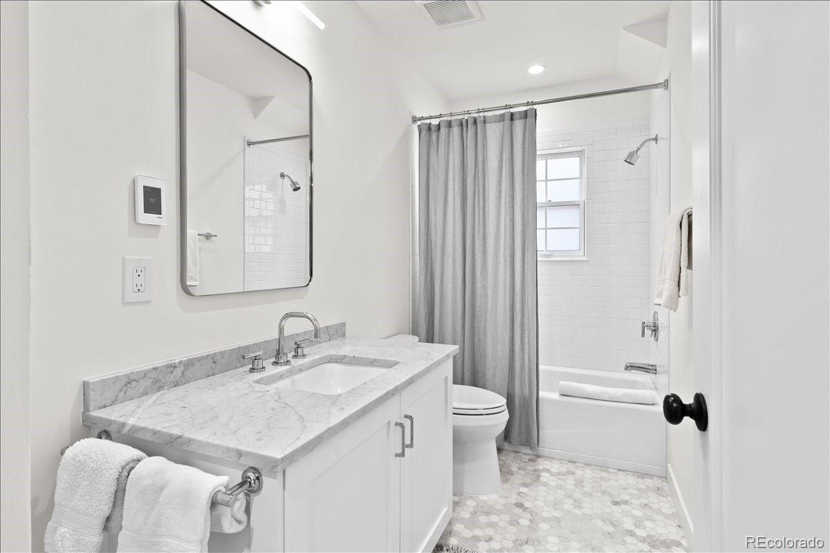535 Garfield Street Denver, CO 80206 - Photo 39 of 50 a bathroom with a sink toilet and shower
