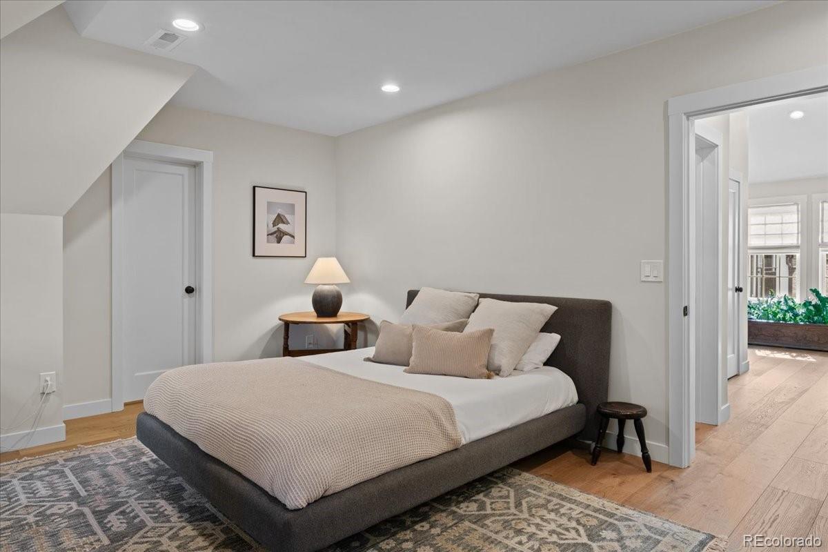 535 Garfield Street Denver, CO 80206 - Photo 41 of 50 a bedroom with double bed and a night stand