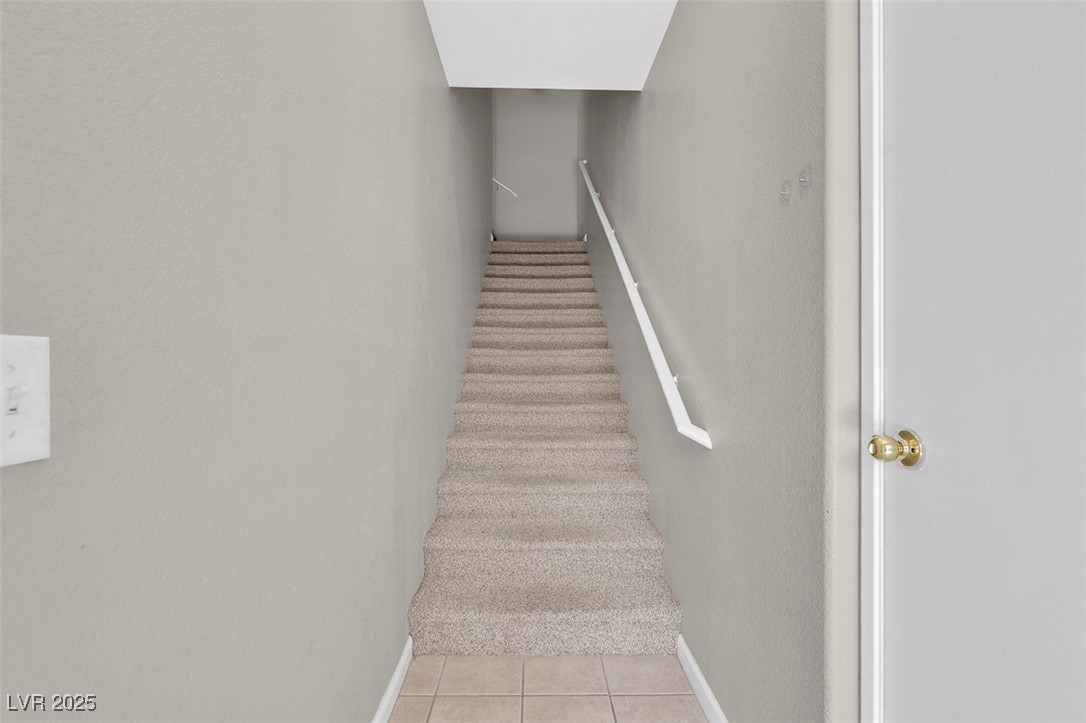 10550 West Alexander Road, Unit 2064 Las Vegas, NV 89129 - Photo 4 of 51 Stairs with tile patterned floors and baseboards